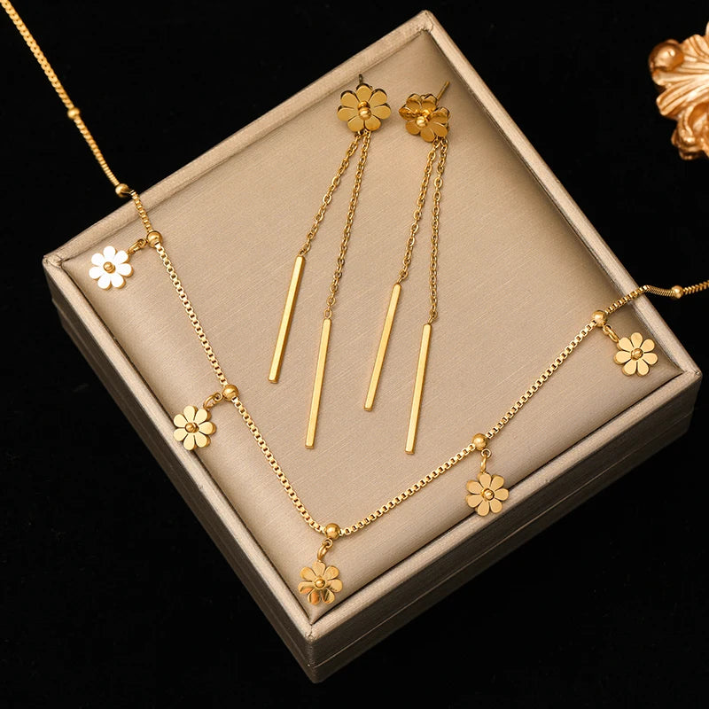 A stainless steel gold-colored flower and heart love necklace and earrings set