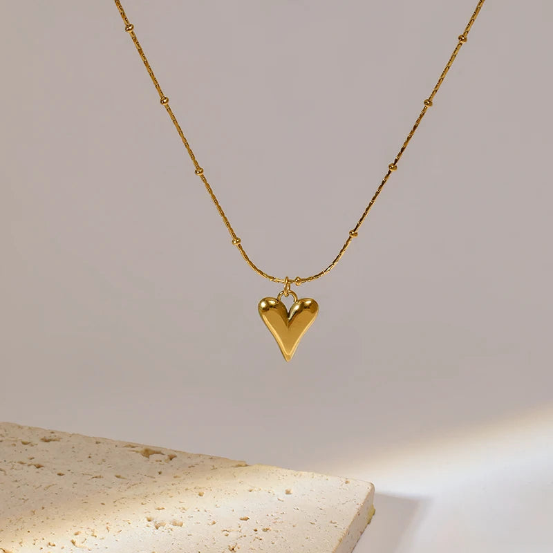 A stainless steel gold-colored flower and heart love necklace and earrings set