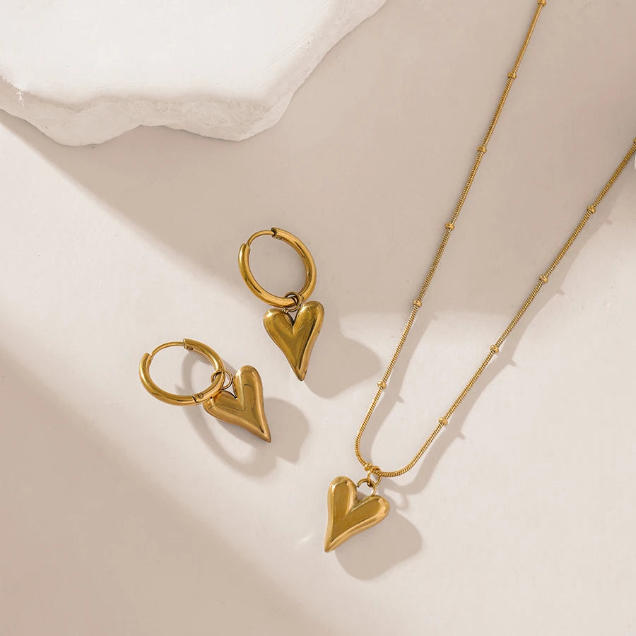 A stainless steel gold-colored flower and heart love necklace and earrings set