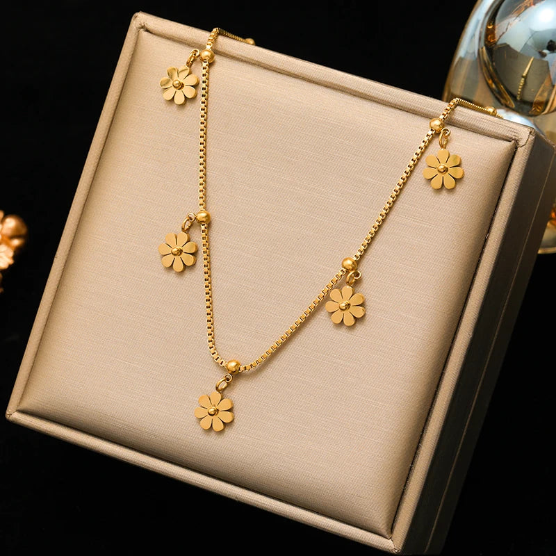 A stainless steel gold-colored flower and heart love necklace and earrings set