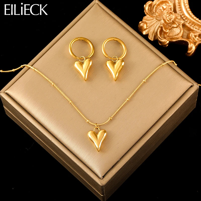 A stainless steel gold-colored flower and heart love necklace and earrings set