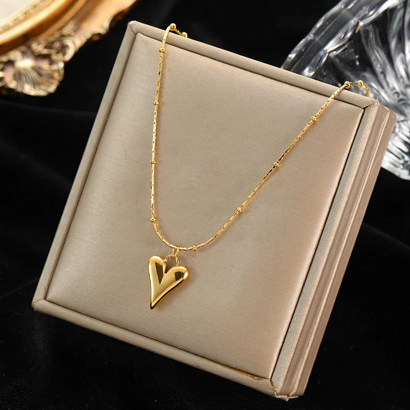 A stainless steel gold-colored flower and heart love necklace and earrings set