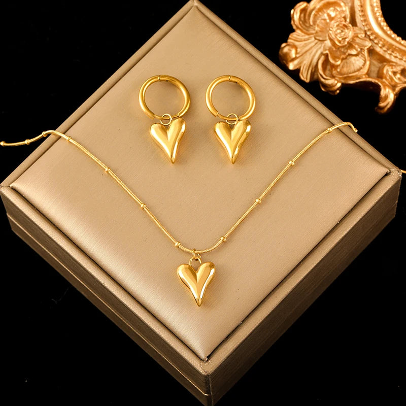 A stainless steel gold-colored flower and heart love necklace and earrings set